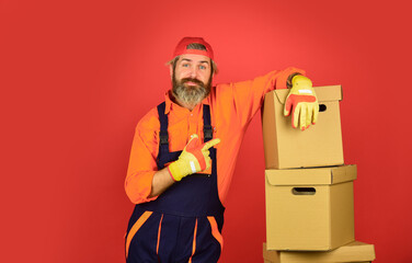 Moving concept. Moving house day. think outside the box. express delivery concept. Man worker in boilersuit at box. moving to new apartment. New Wave of Living. box for tools