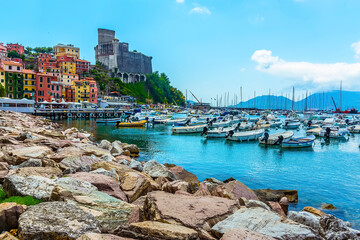 A view along the breakwater towards the castle at Lerici, Italy in the summertime