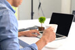 © Chaiyuth - Businessman office workplace By using a computer with a cup of coffee