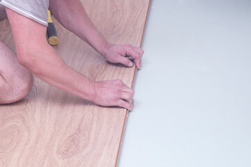 Laminate. Installing laminate at home on a plywood floor.