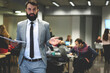 © BullRun - Half length portrait of confident leader of working IT team standing on copy space area dressed in elegant formal suit, prosperous business coach preparing for making speech on workshop for students