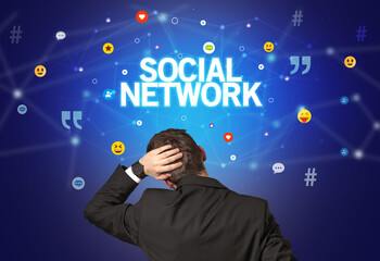 rear view of a businessman with social network inscription, social networking concept