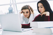 © BullRun - Tired blonde student watching webinar together with friend on laptop computer device connecting to wireless high speed 4G internet.Concentrated young women studying at modern technology in college