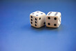 © SANTIAGO - Two rubber dice on a blue background