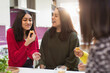 © Sam Edwards/Caia Image - Happy women eating and talking in kitchen