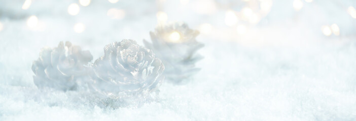 Wall Mural - christmas winter background panorama with pine cones in snow and bokeh lights - greeting card, banne
