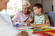 © pikselstock - Mother helping her kids doing homework at home