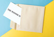 © kemaltaner - The winner is text with an envelope, competition and prize concept