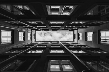 Wall Mural - Rectangle sky view from the bottom of the small courtyard between the buildings