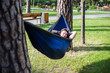 © Hennadii - Young guy has a rest in summer in a hammock