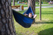 © Hennadii - Young guy has a rest in summer in a hammock