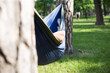 © Hennadii - Young guy has a rest in summer in a hammock