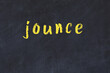 College chalk desk with the word jounce written on in