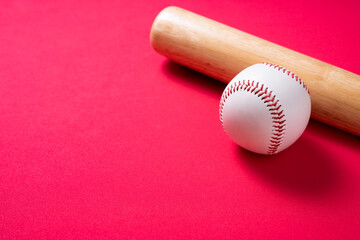 Wall Mural - baseball and baseball bat on red table background, close up