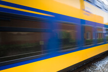 Dutch Double-deck Regional Train With Distinctive Yellow And Blue Color And Large Windows Passing By On A Railway In Heerenveen In The Netherlands