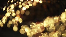 Close-up Of A Rotation In A Circle Of Yellow Bokeh Lights. Christmas Night Lights Bokeh Background Beautifully Rotate.