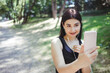 © Vadym - Enjoy music, clear sound, freedom, technology. Sporty woman choosing workout soundtrack at outdoor training