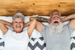 © Alessandro Biascioli - Happy senior couple in bed - Hipster mature people having funny bed time together - Elderly lifestyle and love relationship concept
