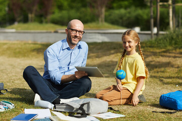 Wall Mural - full length portrait of smiling bald teacher looking at camera while enjoying outdoor astronomy less