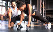 © ty - Sporty woman doing push-up in a gym, her boyfriend is watching her.