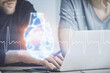 © peshkova - Heart drawing with man working on computer on background. Medical concept. Double exposure.
