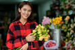 © PK Studio - young woman small business florist arranging plants in flower shop