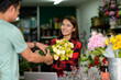 © PK Studio - young woman small business florist arranging plants in flower shop
