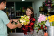 © PK Studio - young woman small business florist arranging plants in flower shop
