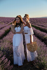 Wall Mural - sexy woman with blond hair in elegant clothes with accessories posing in blooming lavender fields