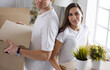 © lenets_tan - Cute couple unpacking cardboard boxes in their new home