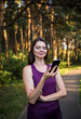 © Яна Айбазова - Young brunette girl talking on the phone in nature at sunset