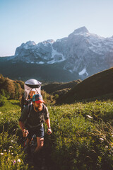 Wall Mural - Father hiking with child daughter in backpack family travel vacation outdoor in mountains adventure holidays with kids healthy lifestyle summer activity