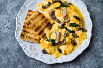 Canvas Print - creamy scrambled eggs with mushrooms and spinach