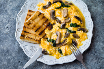 Canvas Print - creamy scrambled eggs with mushrooms and spinach