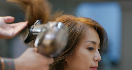 Wall Mural - Woman sit on the chair with hair styling in salon