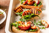 Fototapeta Las - Grilled vegetarian baguette  sandwiches with arugula, grilled peach, black sesame and almond