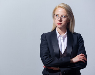 Poster - Beautiful blonde businesswoman in suit on gray background