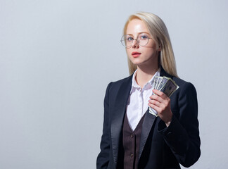 Poster - Beautiful blonde businesswoman in suit with money