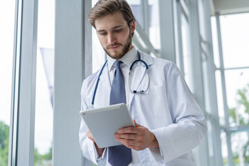 male medical doctor using tablet computer in hospital.