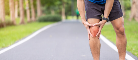 Young adult male with muscle pain during running. runner have knee ache due to Runners Knee or Patellofemoral Pain Syndrome, osteoarthritis and Patellar Tendinitis. Sports injuries and medical concept