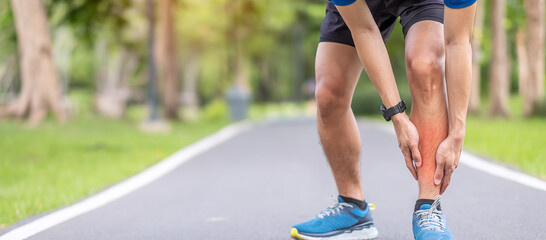 Wall Mural - Young adult male with his muscle pain during running. runner man having leg ache due to Shin Splints. Sports injuries and medical concept