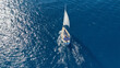 Aerial drone photo of sail boat cruising in the deep blue Aegean sea, Cyclades, Greece
