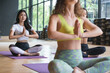 © Supachai - Group yoga woman practicing and meditates in fitness class
