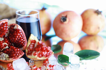 Ripe grains of pomegranate on the table. Pomegranate juice.