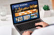 © Prostock-studio - Unrecognizable businesswoman using hotel booking website, office interior