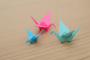 three colorful paper origami cranes