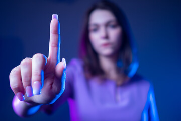 Woman presses a button. Place for a button. Concept - girl makes a choice. Concept - selecting a button on the screen. The student clicks on the monitor. Pressing the display. Decide. Dark background