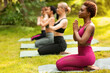 © Prostock-studio - Yoga for inner balance. Group of diverse women meditating at park, blank space
