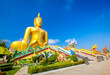 Beautiful of Large golden sitting Buddha statue with the background of blue sky at Wat Muang  temple,Ang Thaong, Thailand