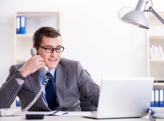 Businessman employee talking on the office phone